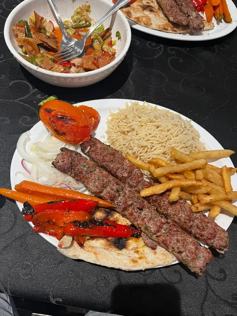 Grilled kebab plate with rice, fries and roasted vegetables